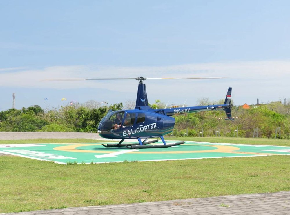 The helicopter waiting on the marked pad