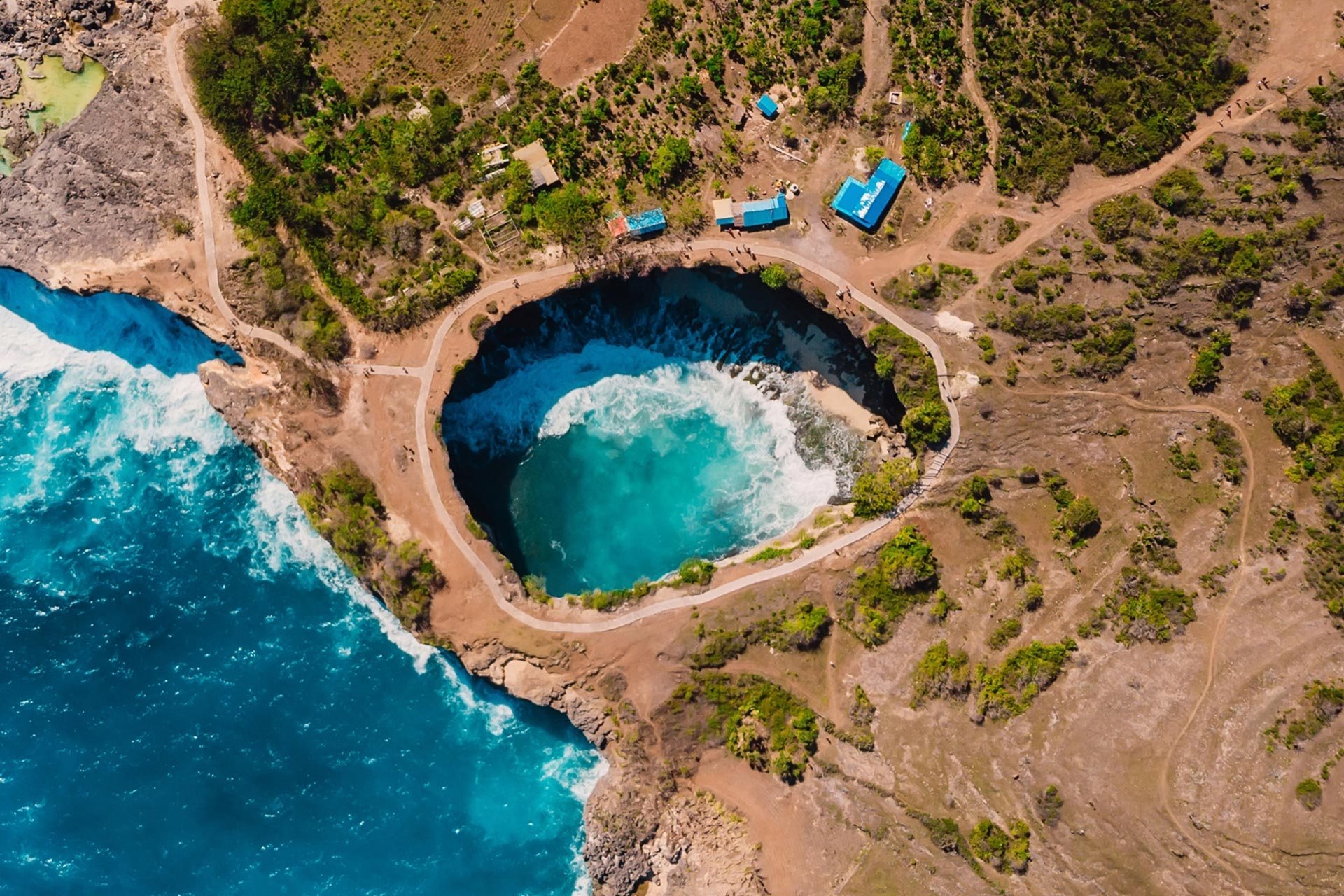 Collapsed sea arch and turquoise water on a limestone coast