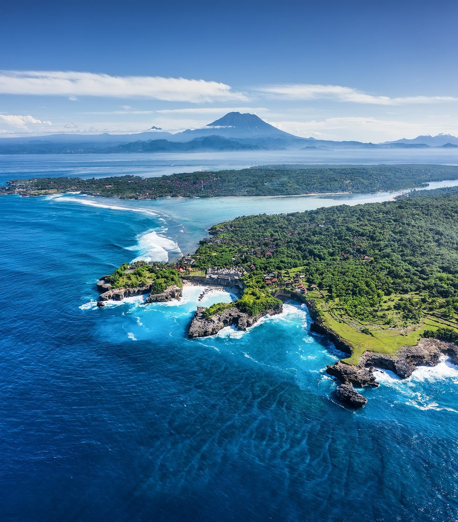 Island channel with a volcano standing on the horizon